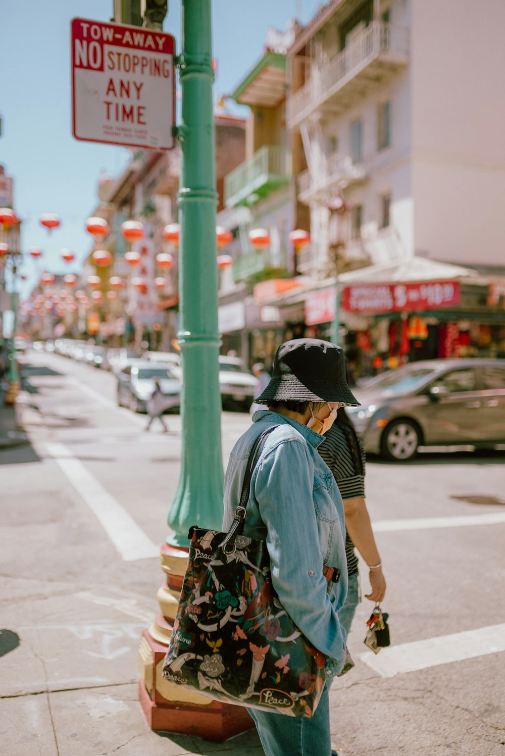 a person walking down a street with a suitcase