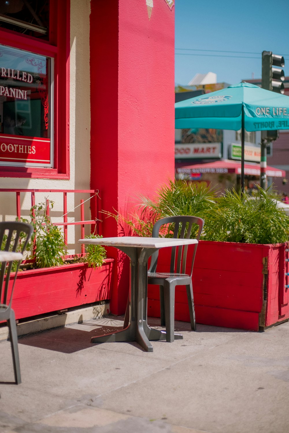 two chairs and a table outside of a restaurant