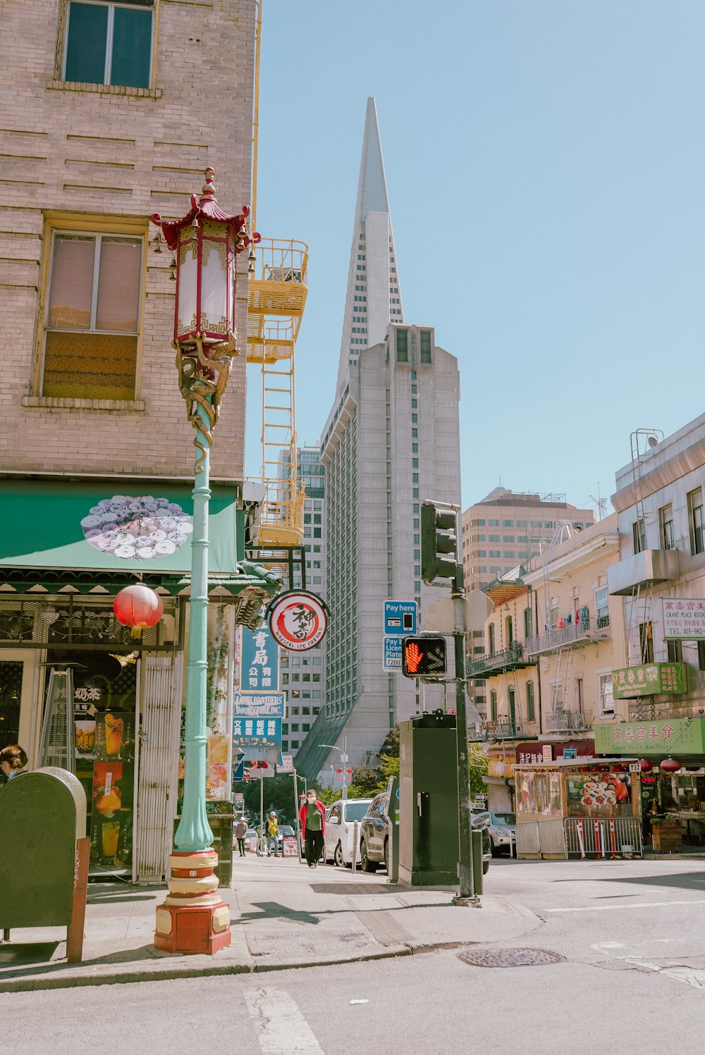 a city street with tall buildings in the background