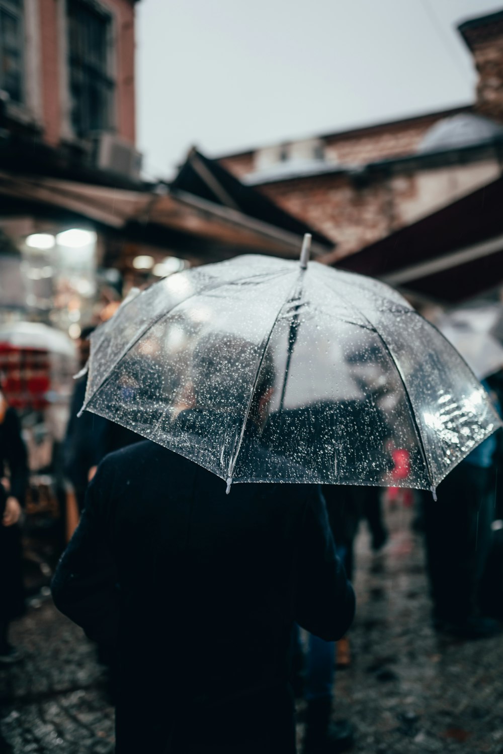 a person holding an umbrella in the rain