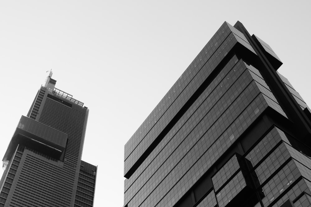 a black and white photo of two tall buildings