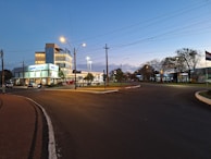 A clean and modern commercial sign illuminated at dusk.
