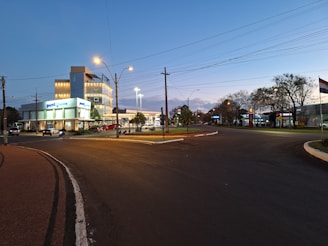 A clean and modern commercial sign illuminated at dusk.