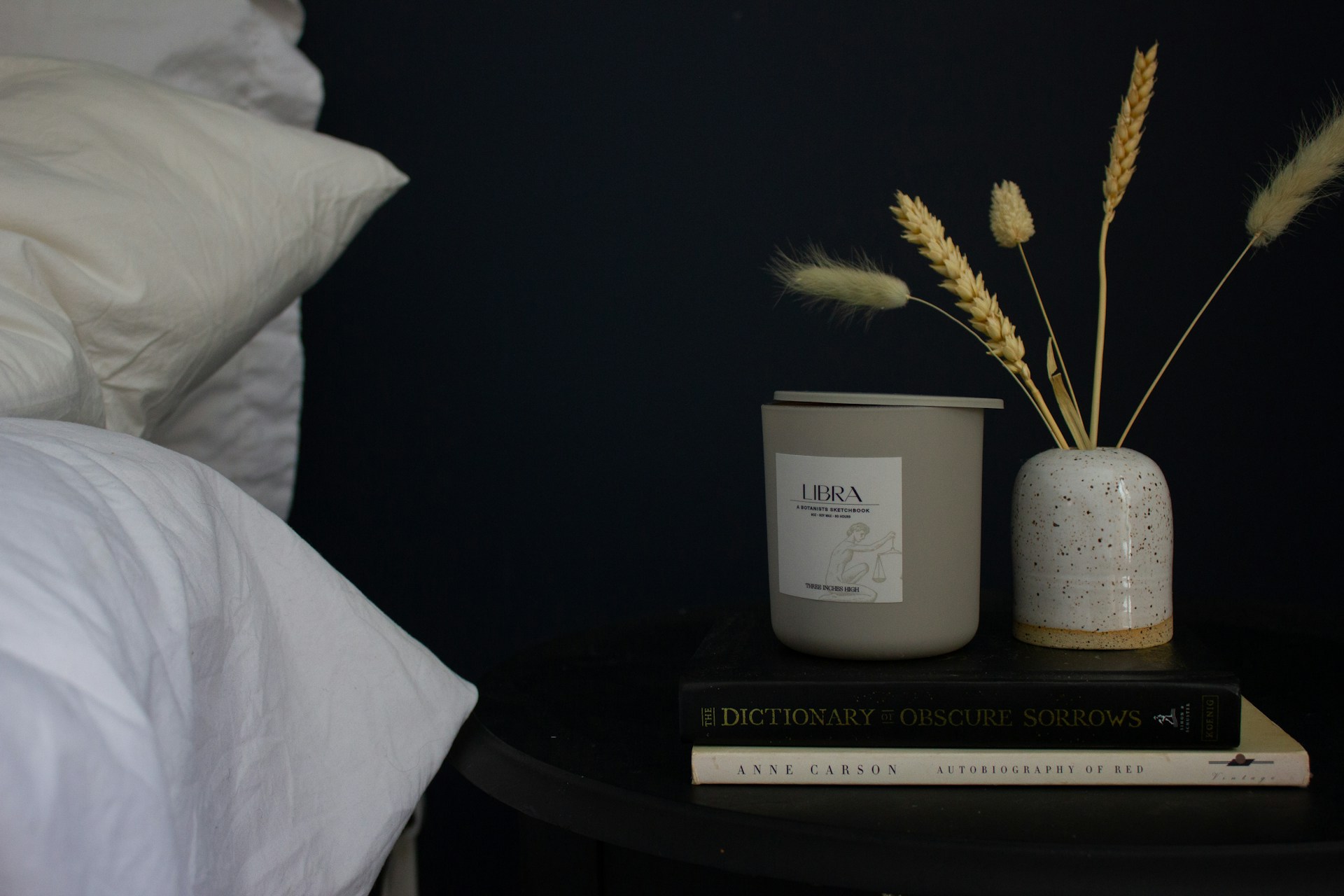 a candle and some books on a table
