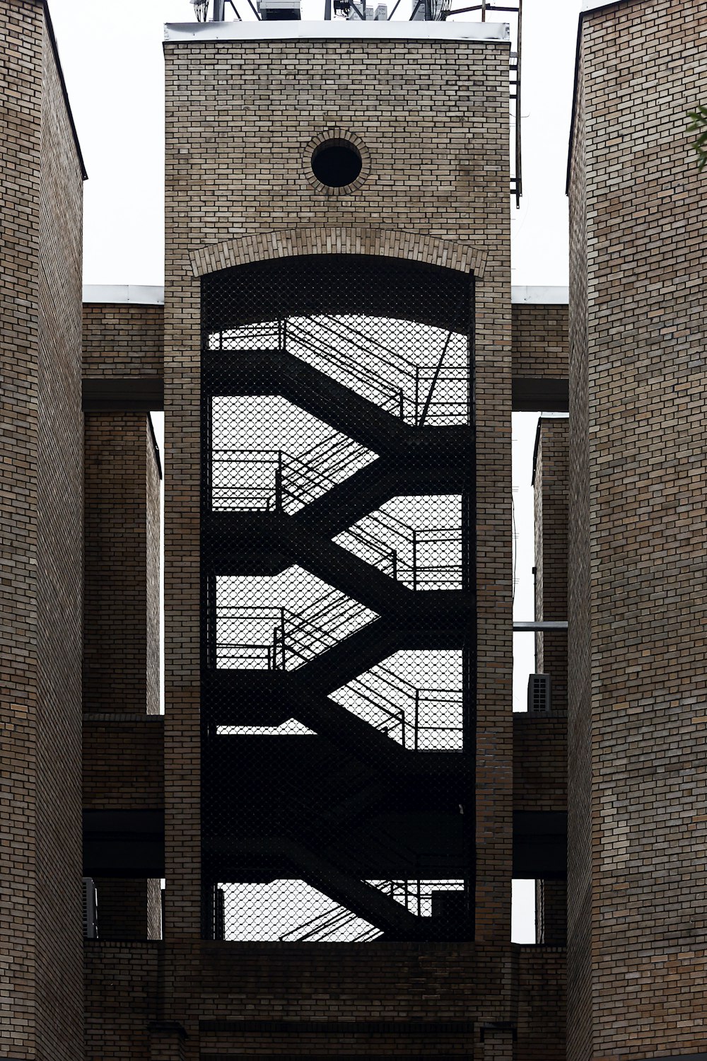 a tall brick building with a clock on it's side