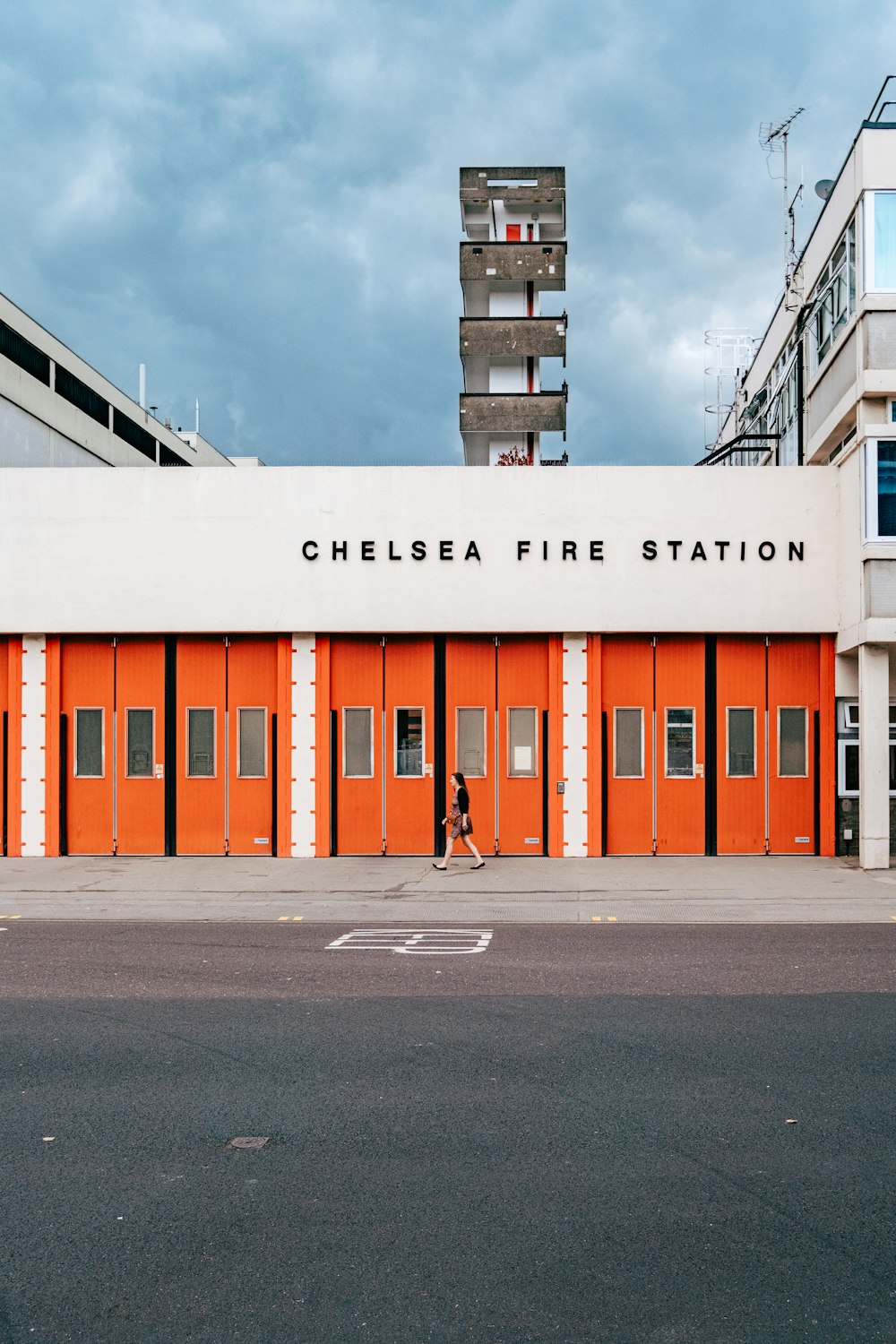 a fire station with a person walking by it