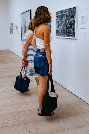 A captivating photo of women artists showcasing their work at an exhibition.
