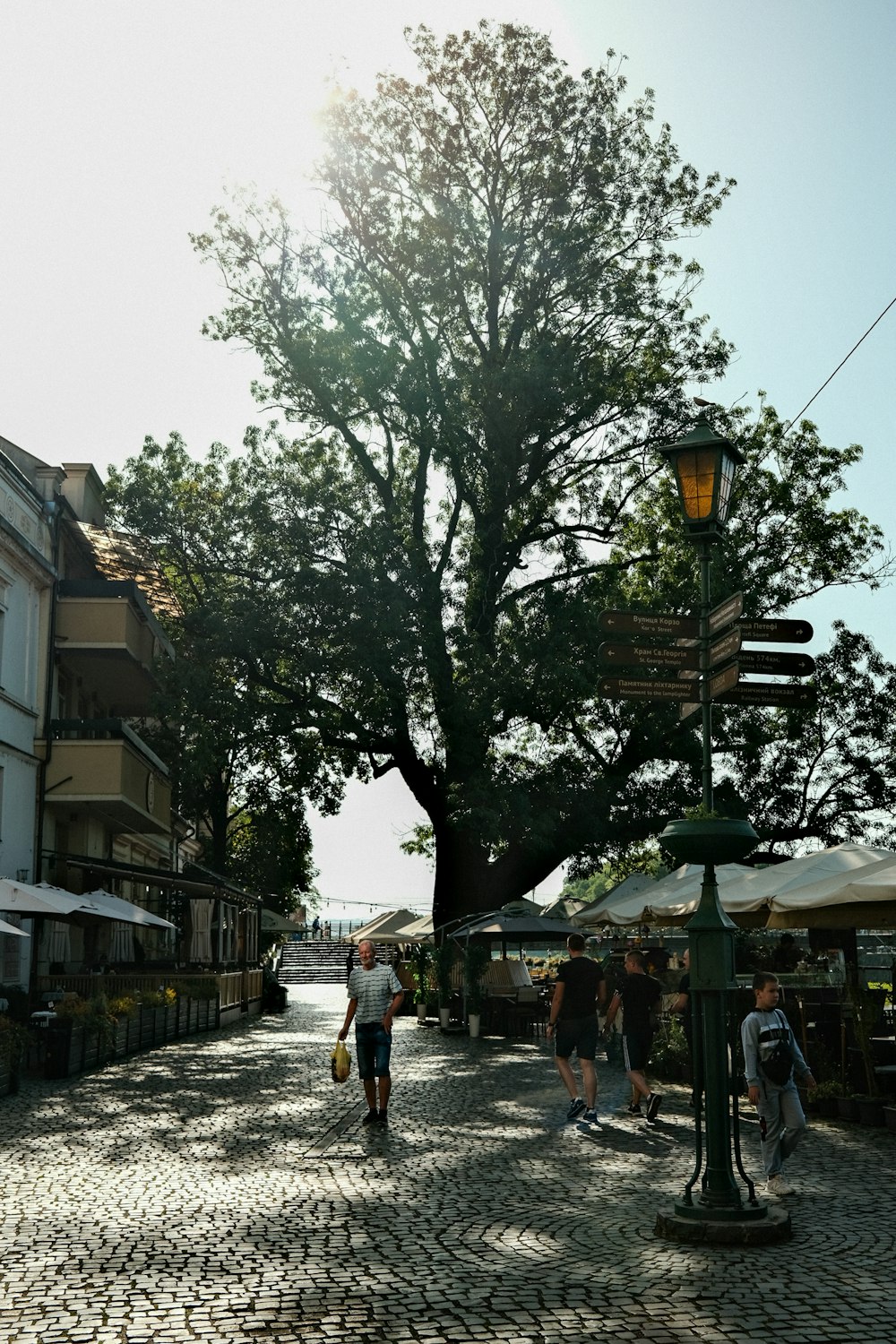 a person walking down a cobblestone street