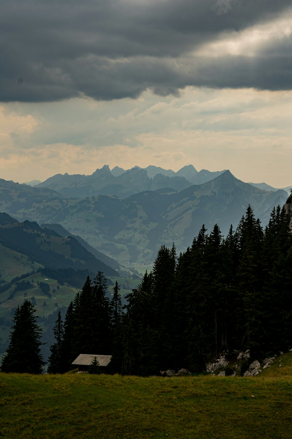 a view of a mountain range with a house in the foreground