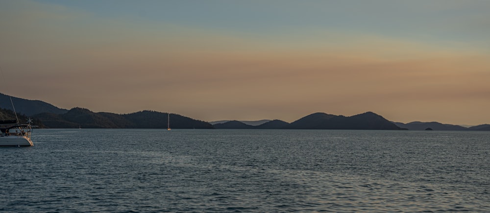 a boat floating on top of a large body of water