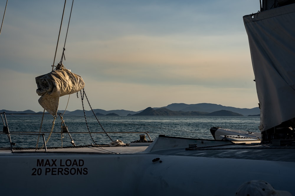 a view of a sailboat in the water with mountains in the background