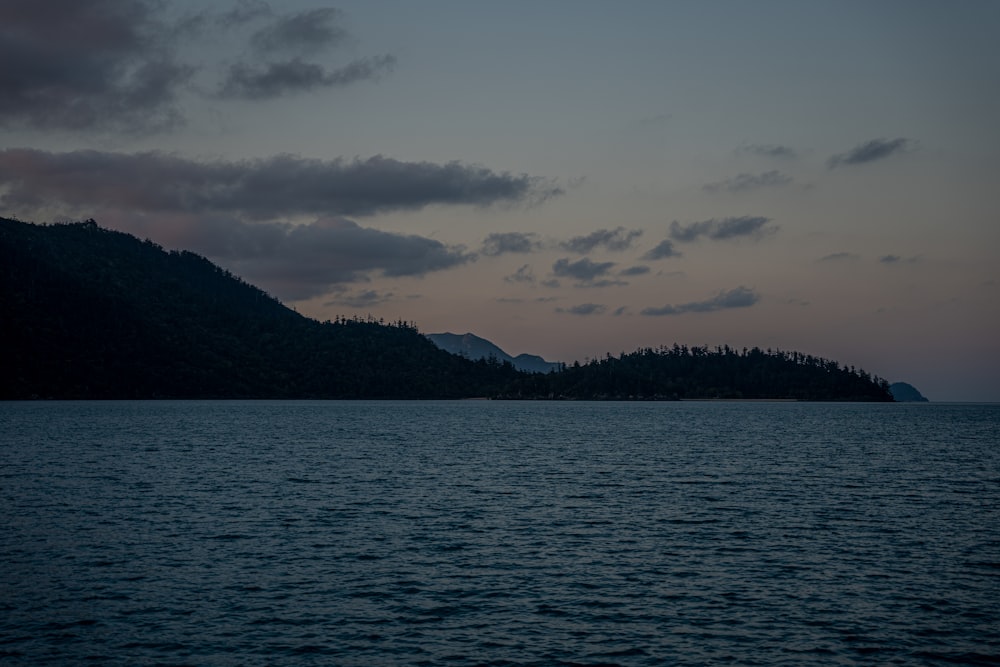 a large body of water sitting under a cloudy sky