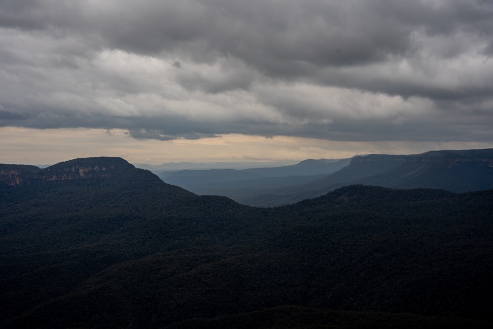 a view of a mountain range under a cloudy sky