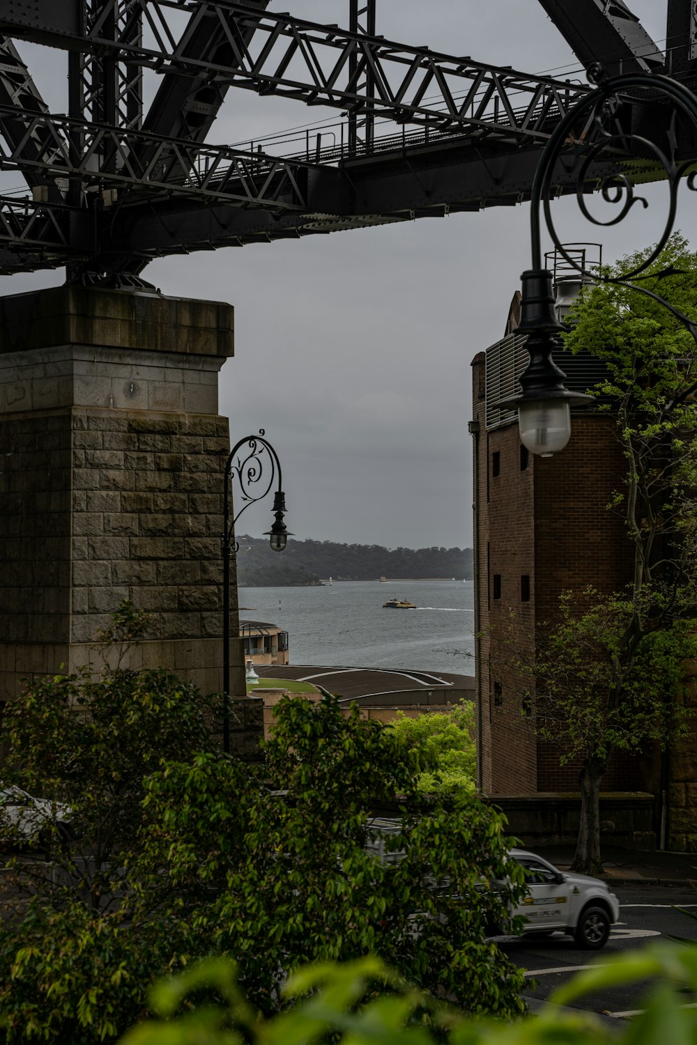 a view of the ocean from under a bridge