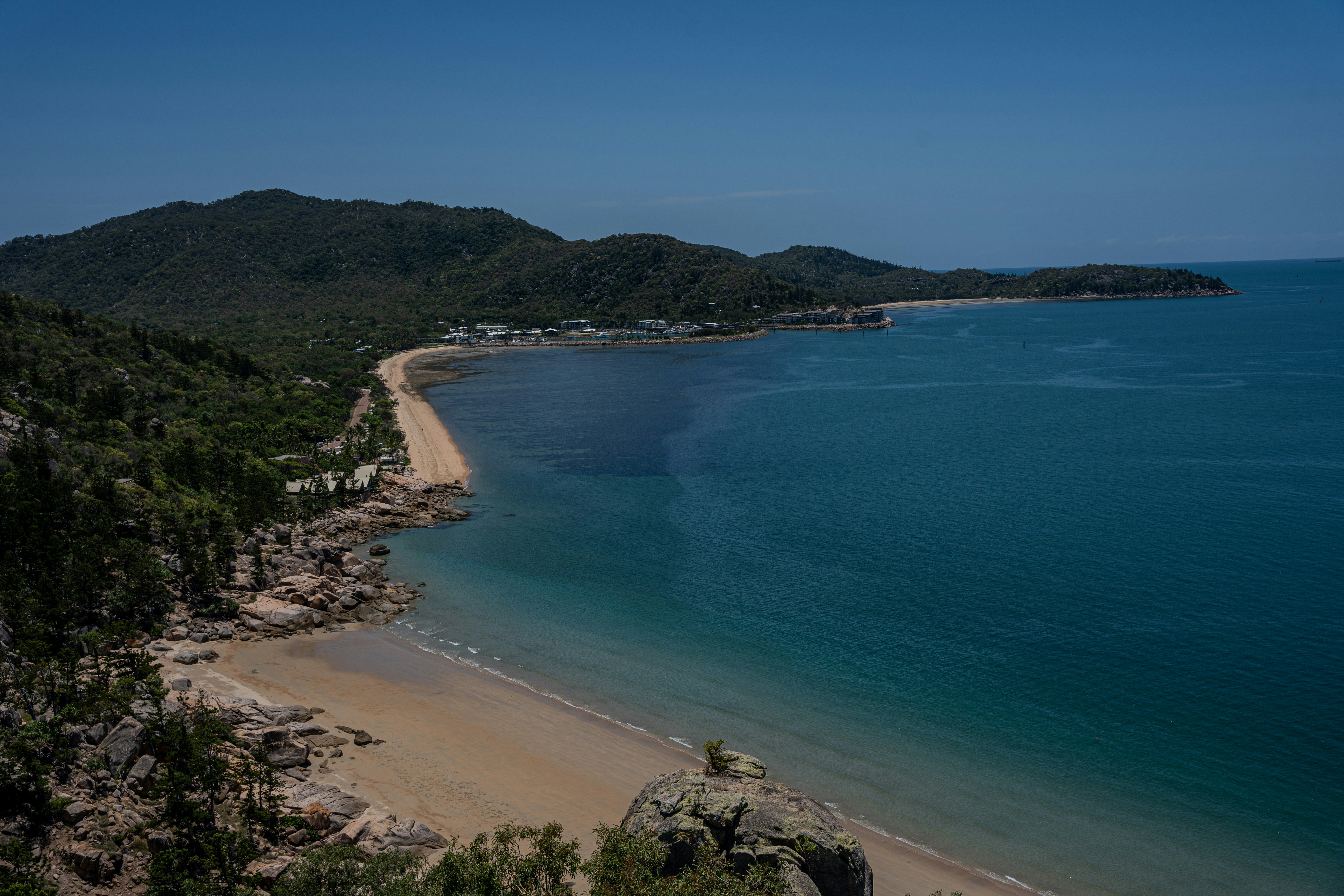 a view of a beach with a mountain in the background