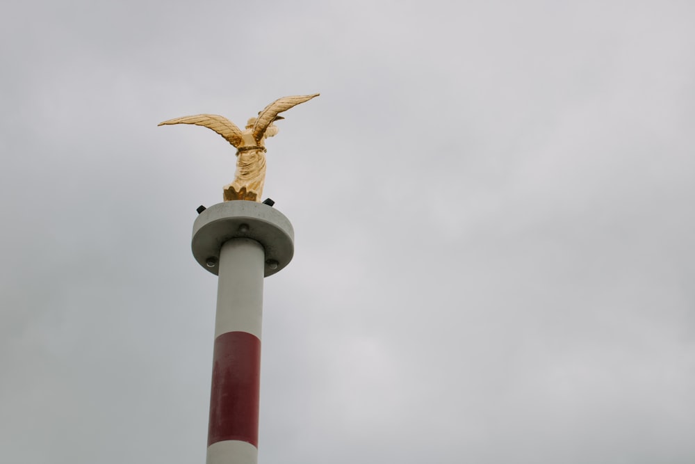 a statue of an eagle on top of a pole