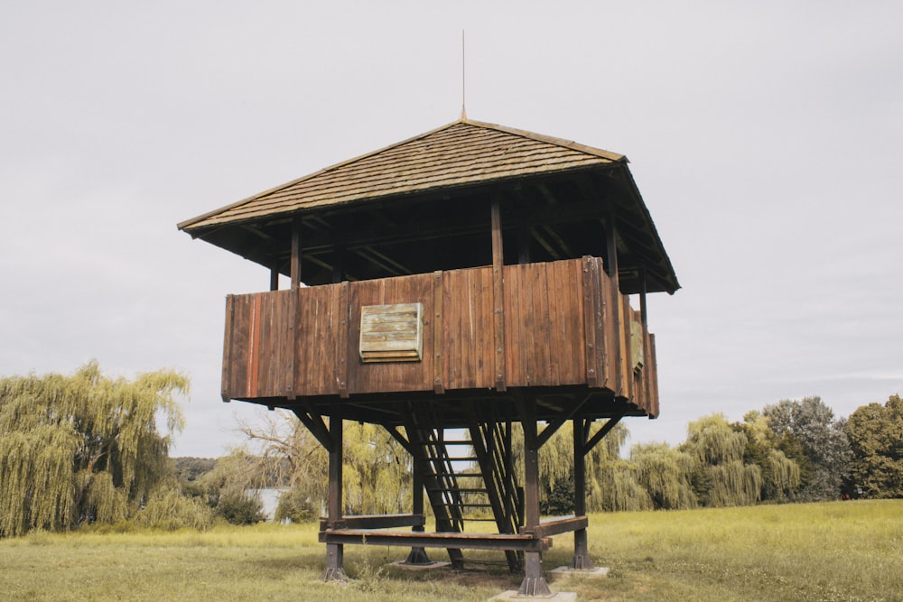 a tall wooden tower with a wooden roof