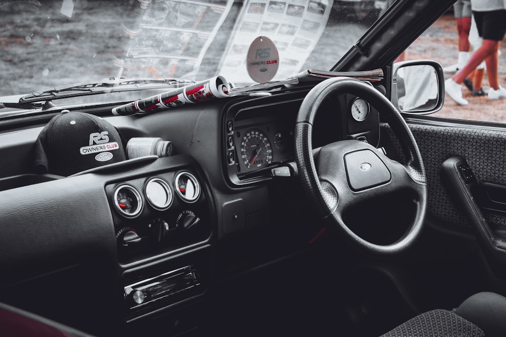 a car dashboard with a steering wheel and a dash board