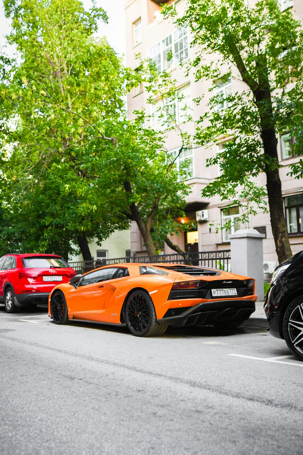 a couple of cars parked on the side of a street