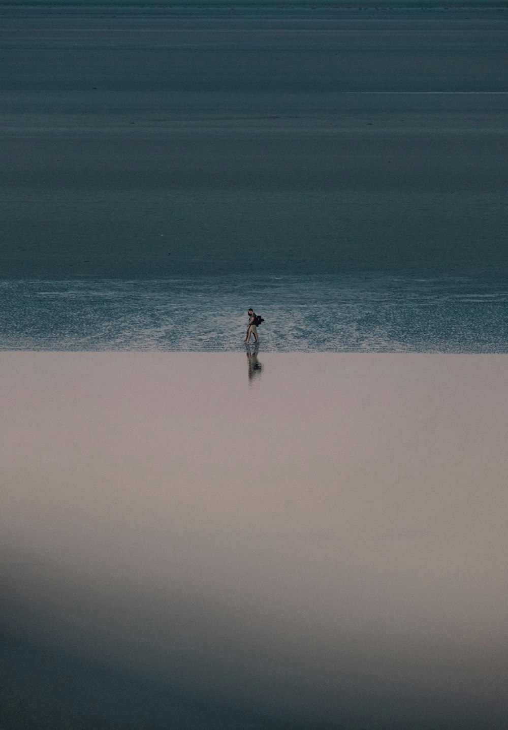 a person standing in the middle of a large body of water