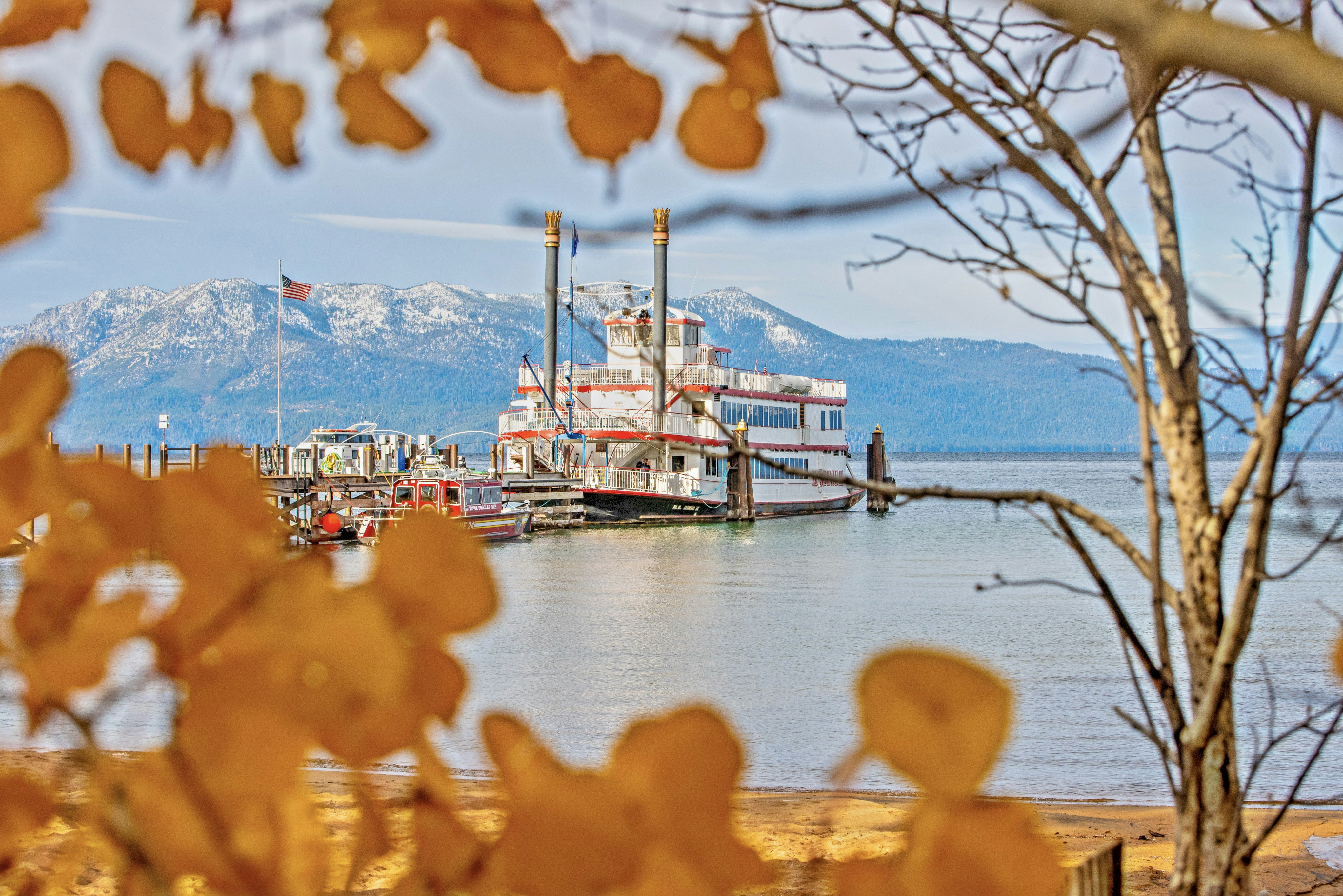 a red and white boat docked at a pier