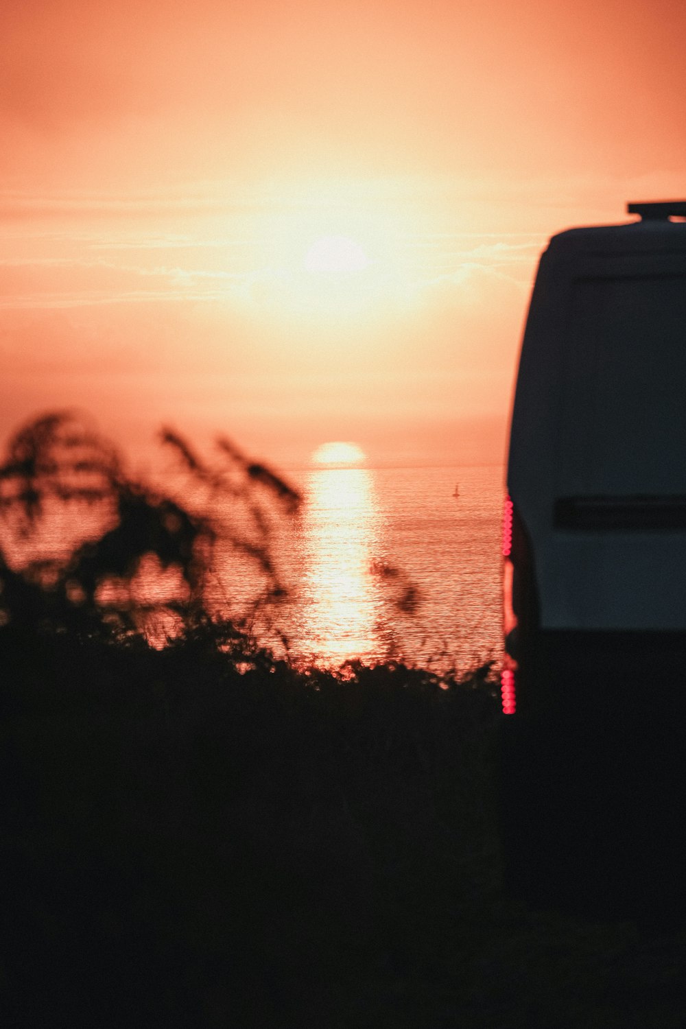 a van is parked in front of a sunset