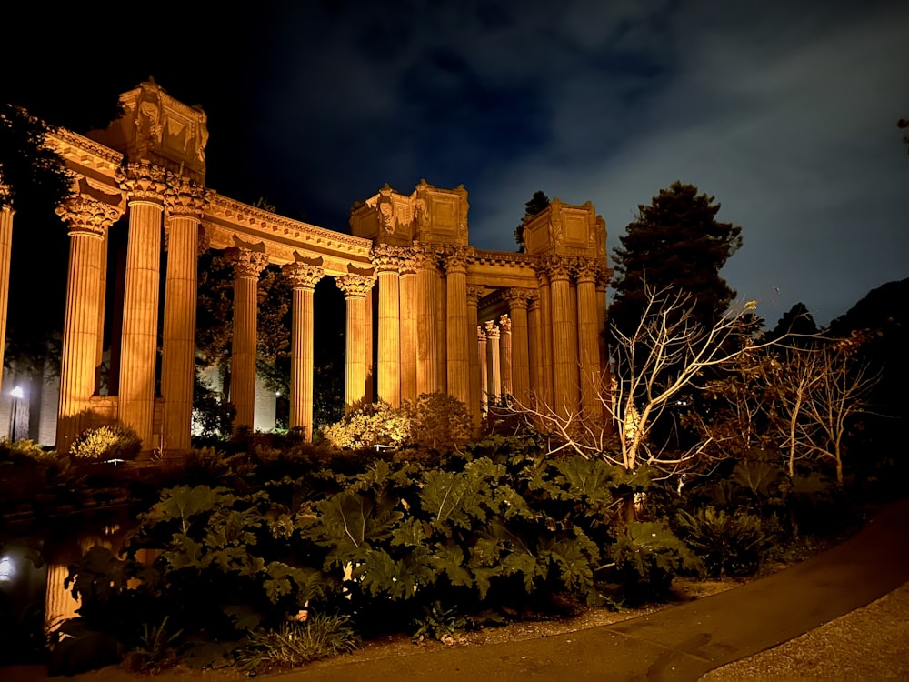 an old building lit up at night with lights on