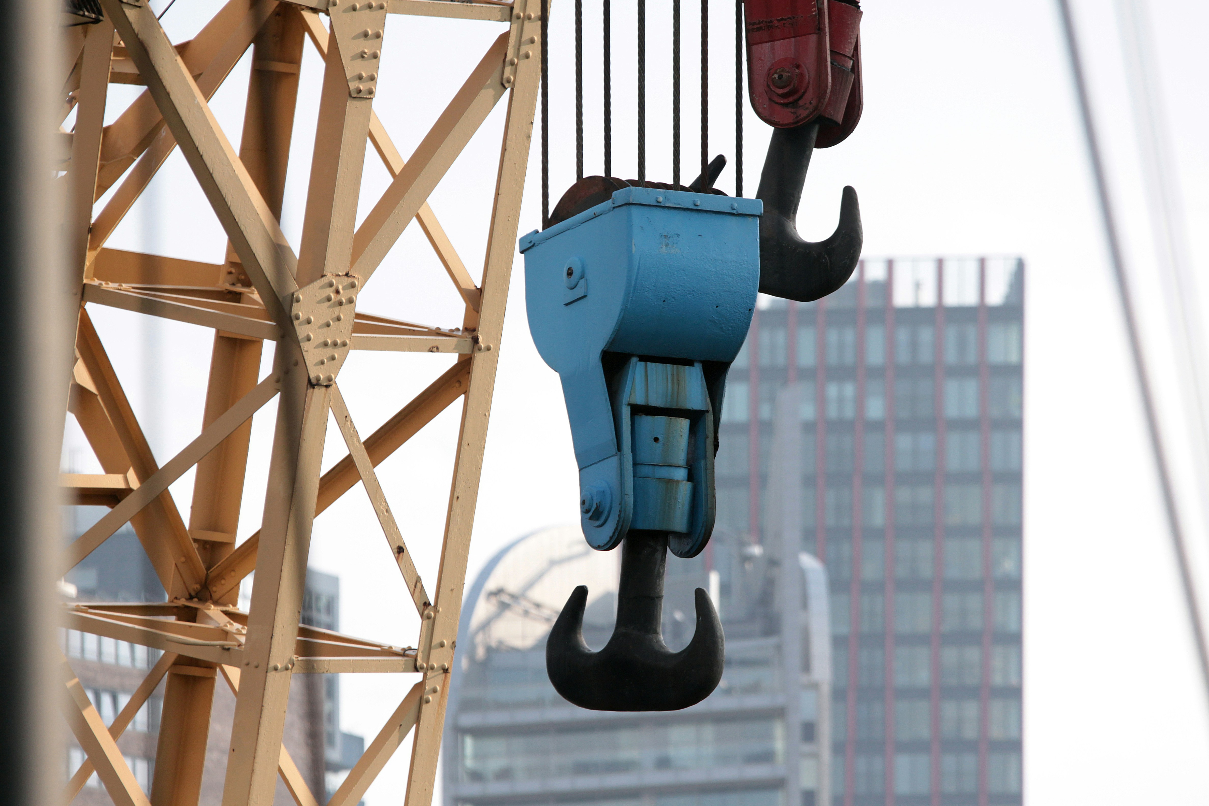 A crane holding a blue box with a red box on it photo – Free Grey Image ...