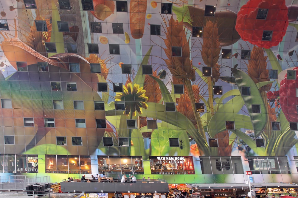 a building with a large mural of flowers on the side of it