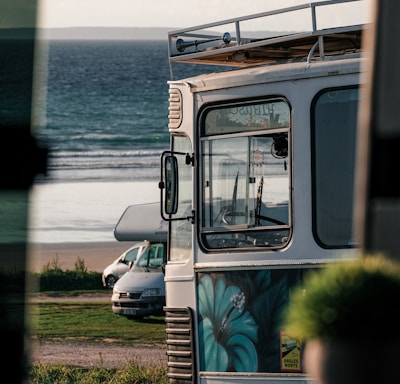 a bus parked on the side of the road next to the ocean