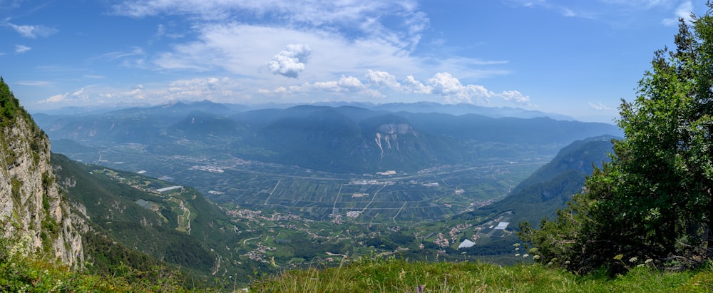 a scenic view of a valley with mountains in the background