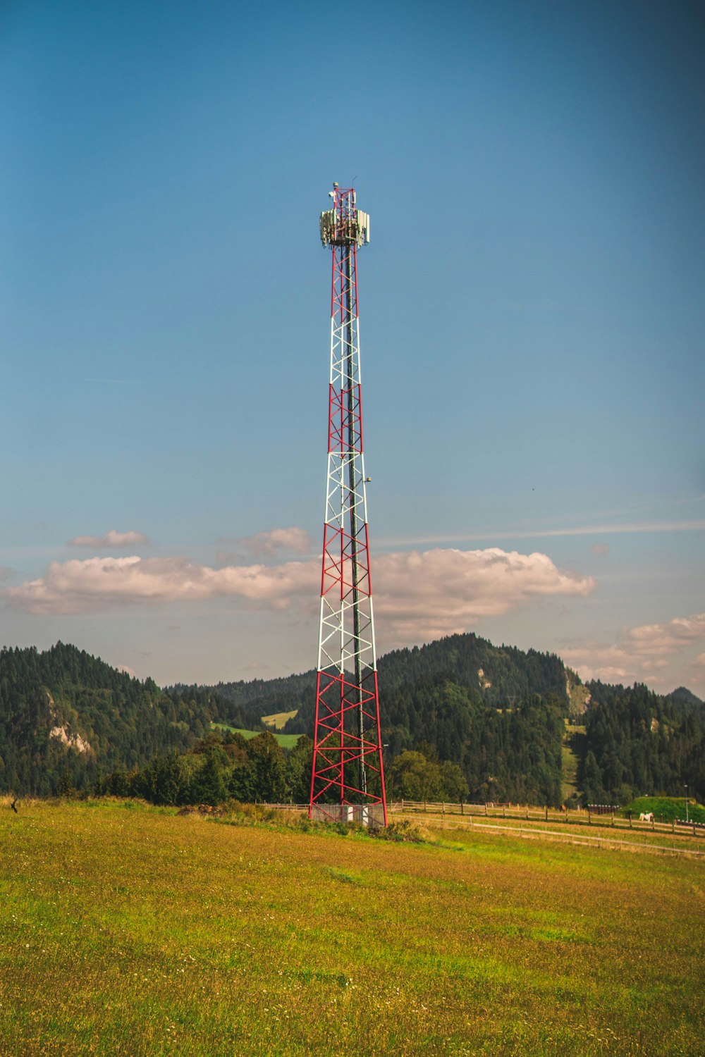 a tall tower sitting in the middle of a field