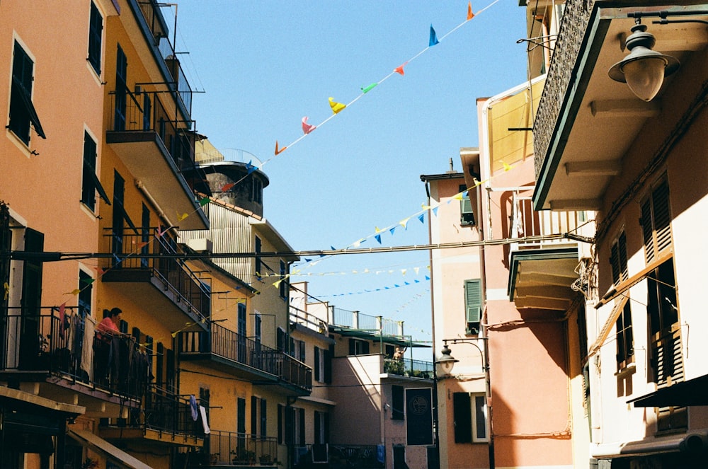 a narrow street with buildings and a clock tower in the distance