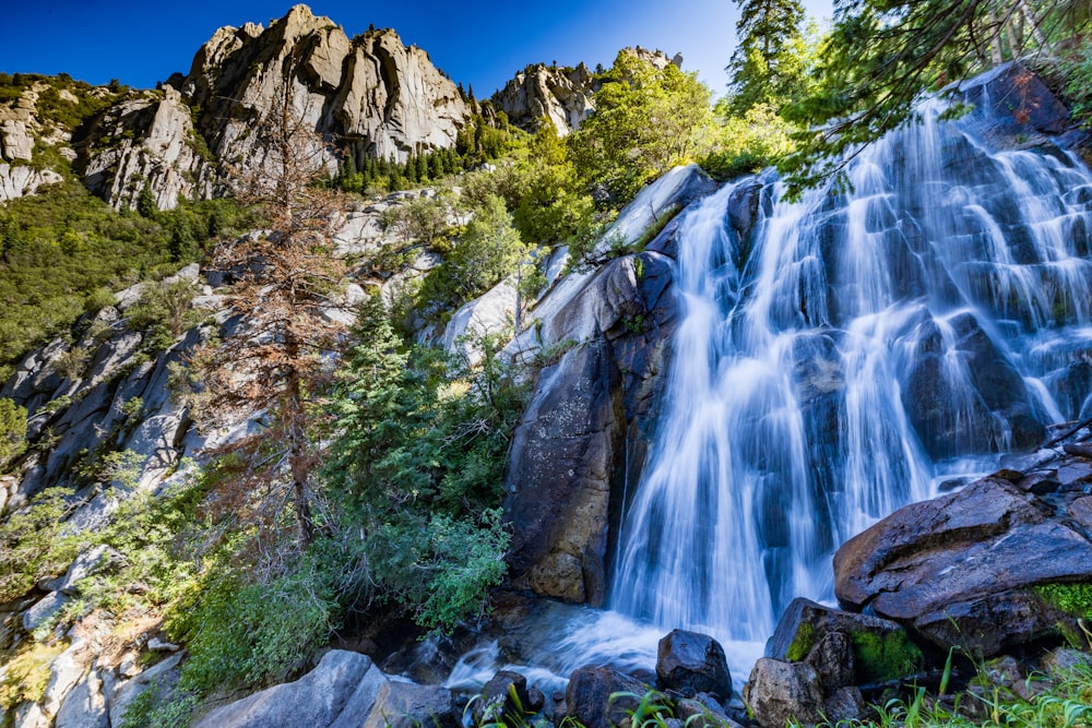 a waterfall with a mountain in the background