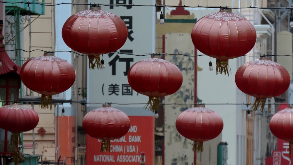 a bunch of red lanterns hanging from a wire