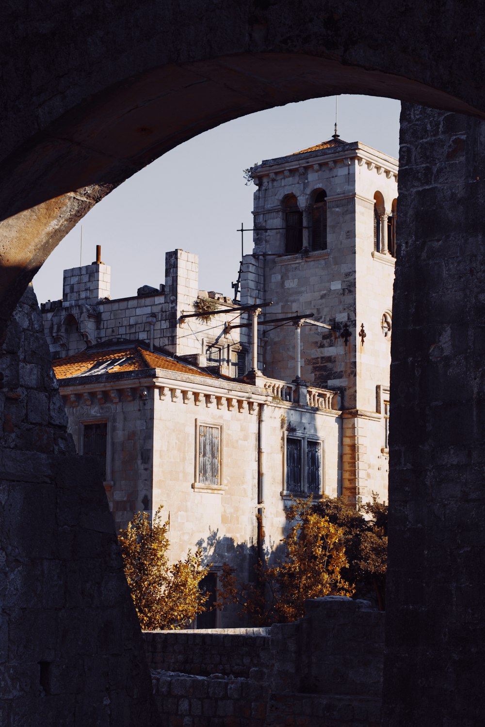 an old building with a clock tower seen through an arch