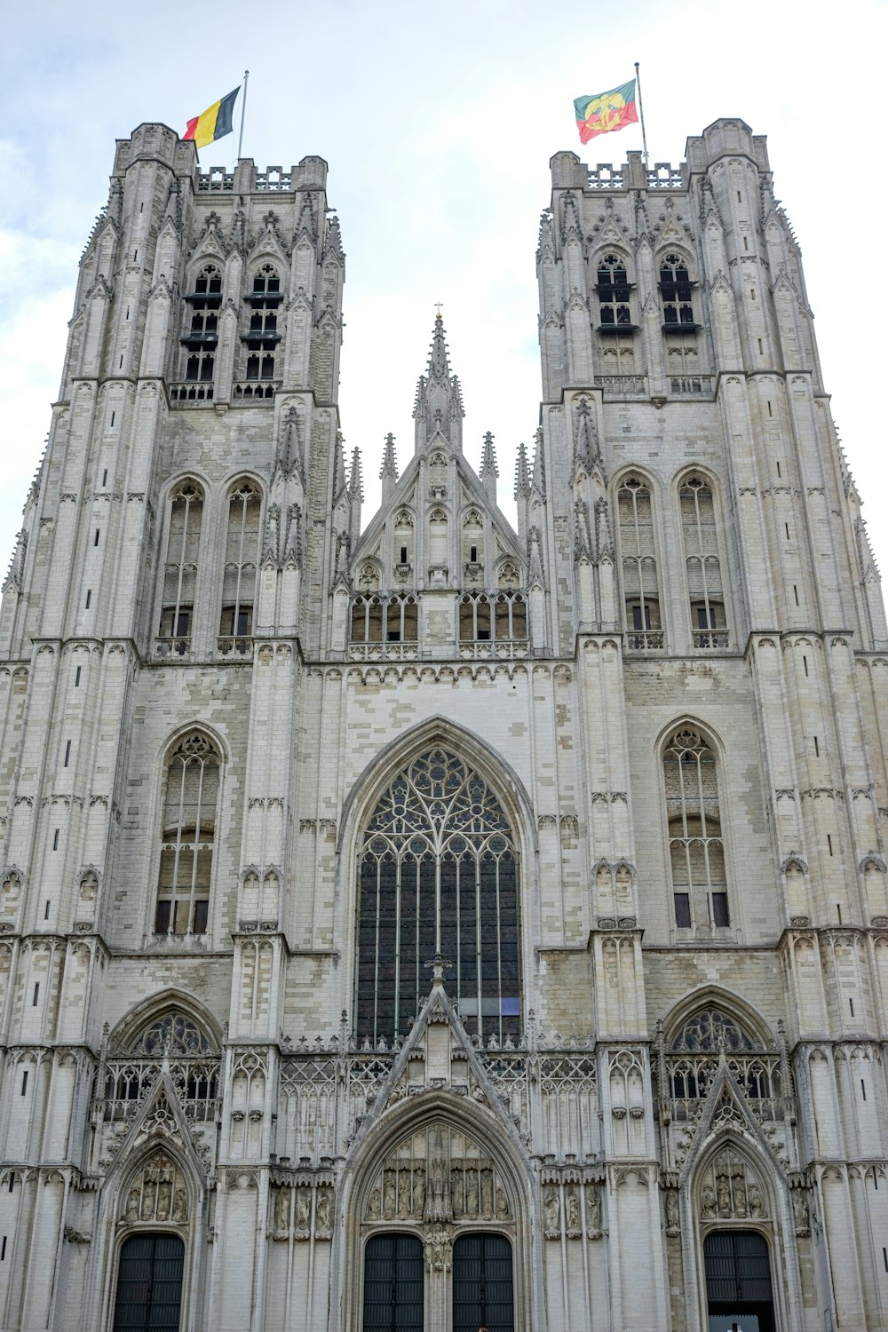 a large cathedral with two flags on top of it