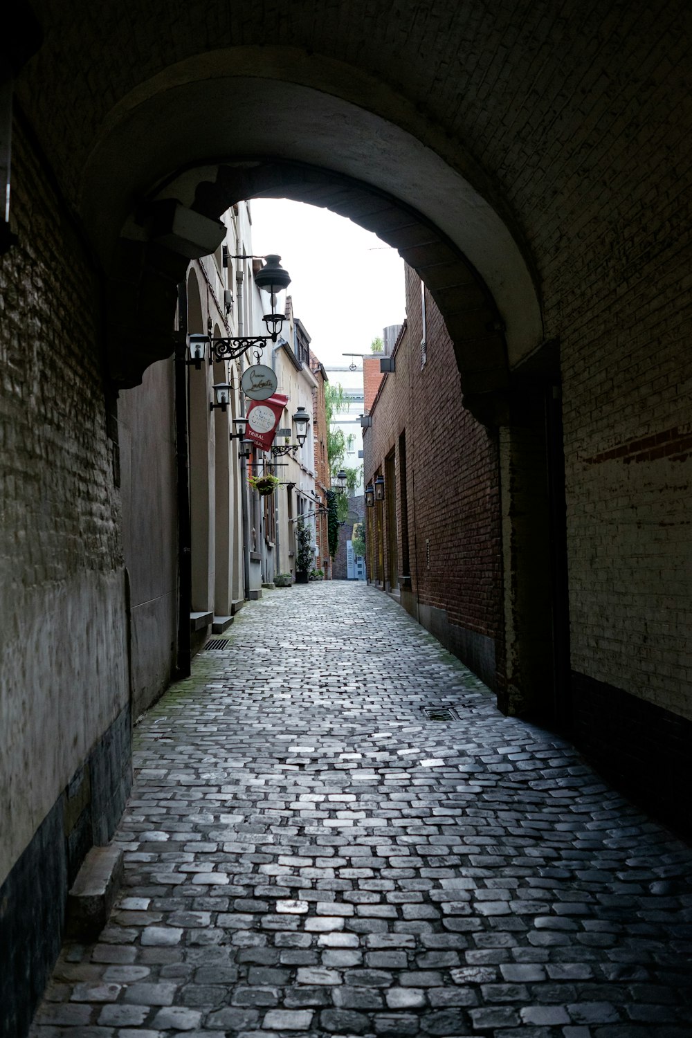 a cobblestone street with a tunnel in the middle