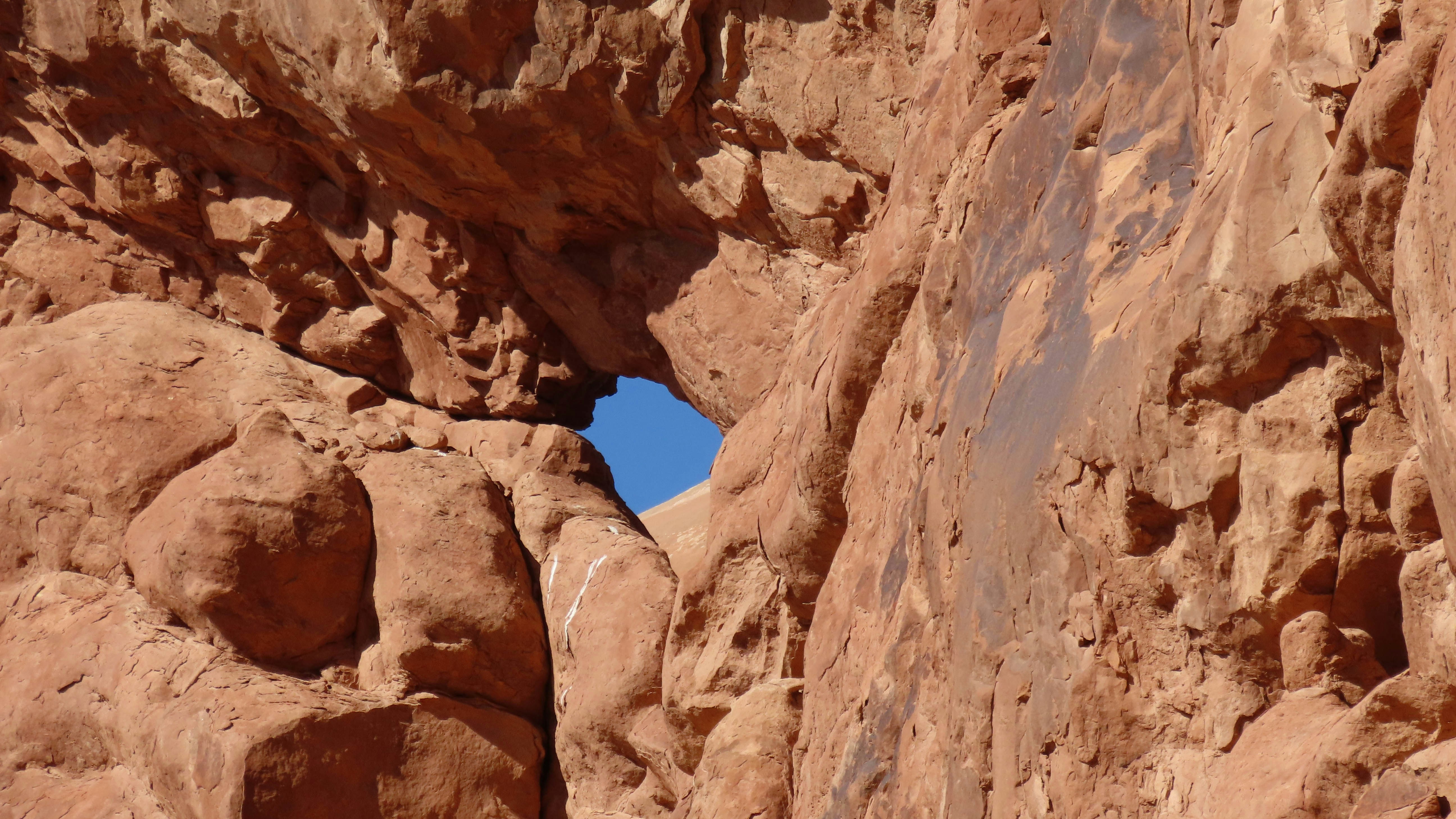 a rock formation with a hole in the middle of it, 