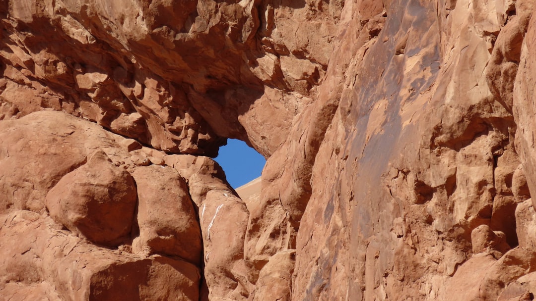 a rock formation with a hole in the middle of it,