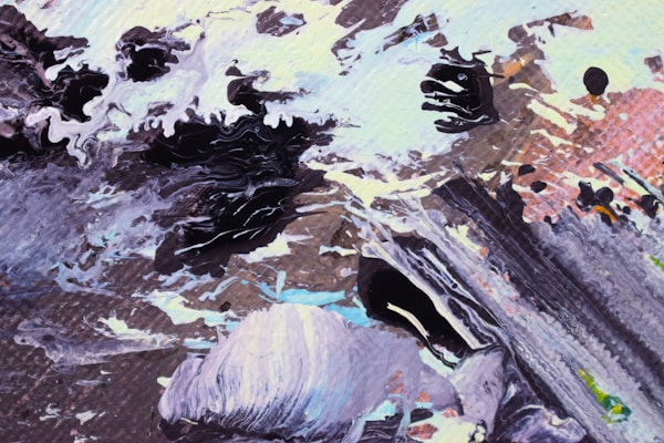 An abstract artwork featuring dynamic swirling patterns of black, white, and earth tones. Layers of paint create texture and movement, suggesting natural elements like rocks and water. The colors blend seamlessly into each other, creating a sense of flow.