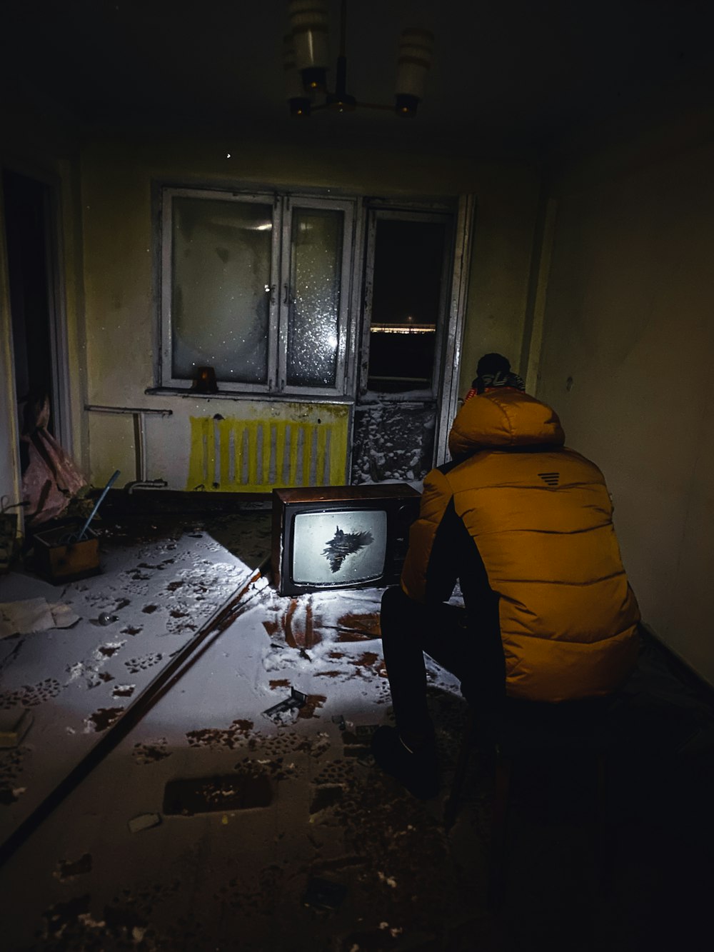 a person sitting in a room with a tv