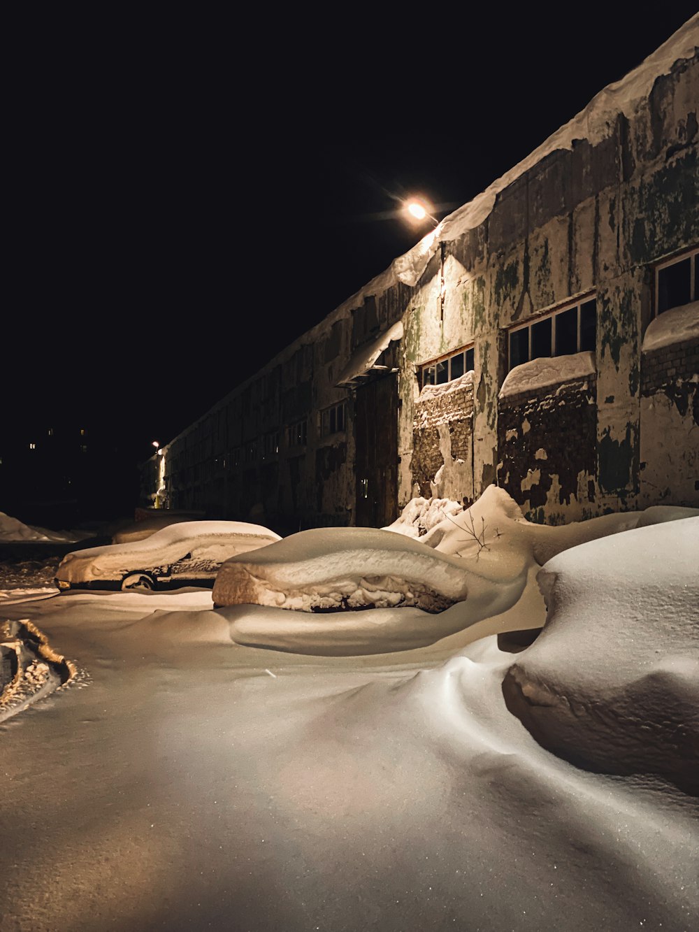 a building that is covered in snow at night