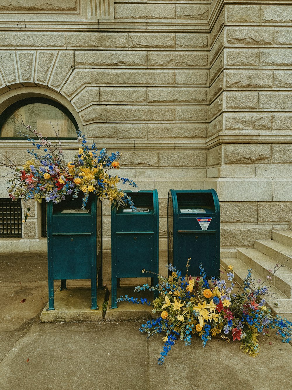 a bunch of flowers that are sitting in front of a mailbox