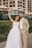 A joyful couple celebrating their wedding day outdoors.