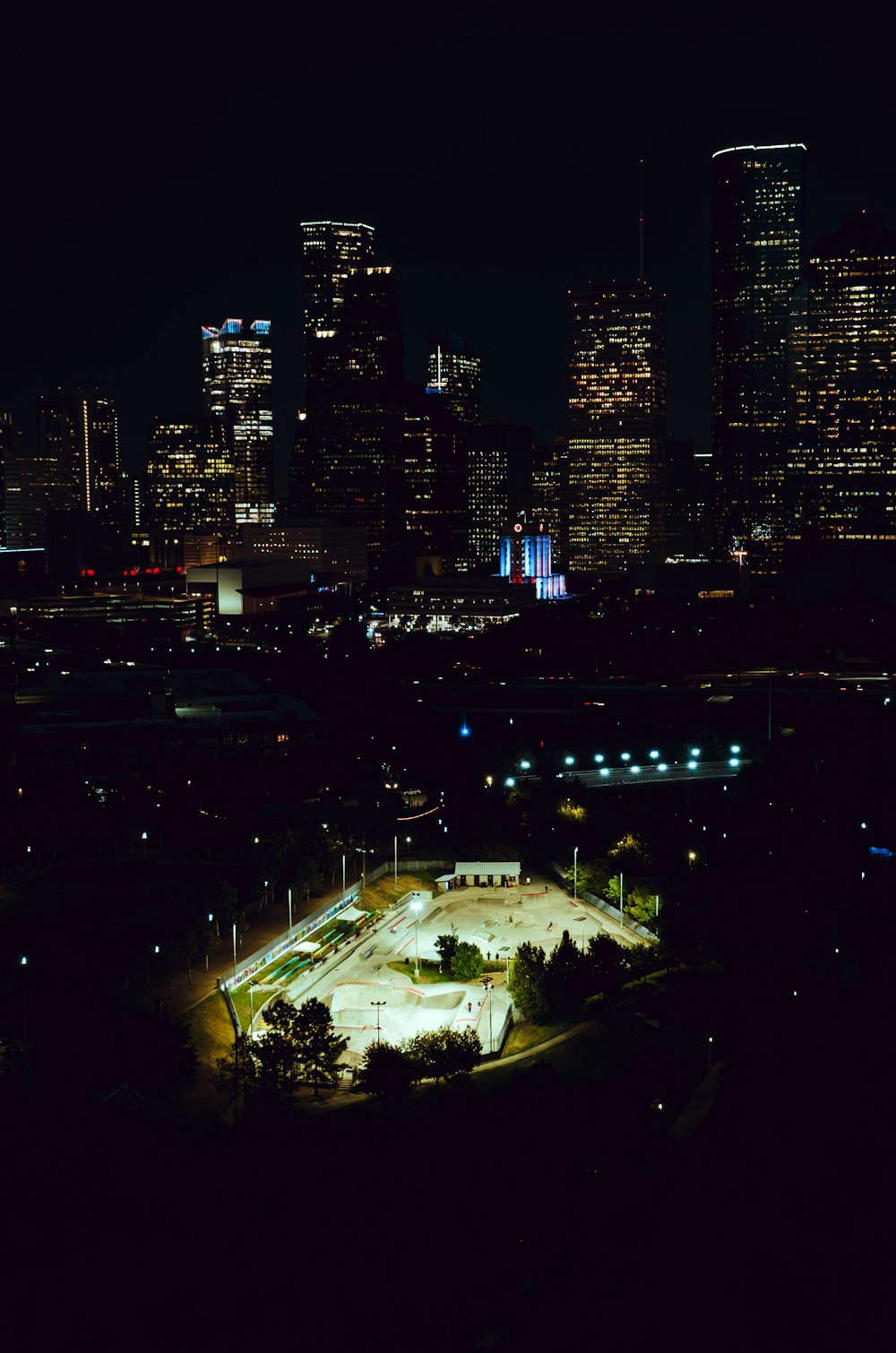 a night view of a city with a lot of tall buildings