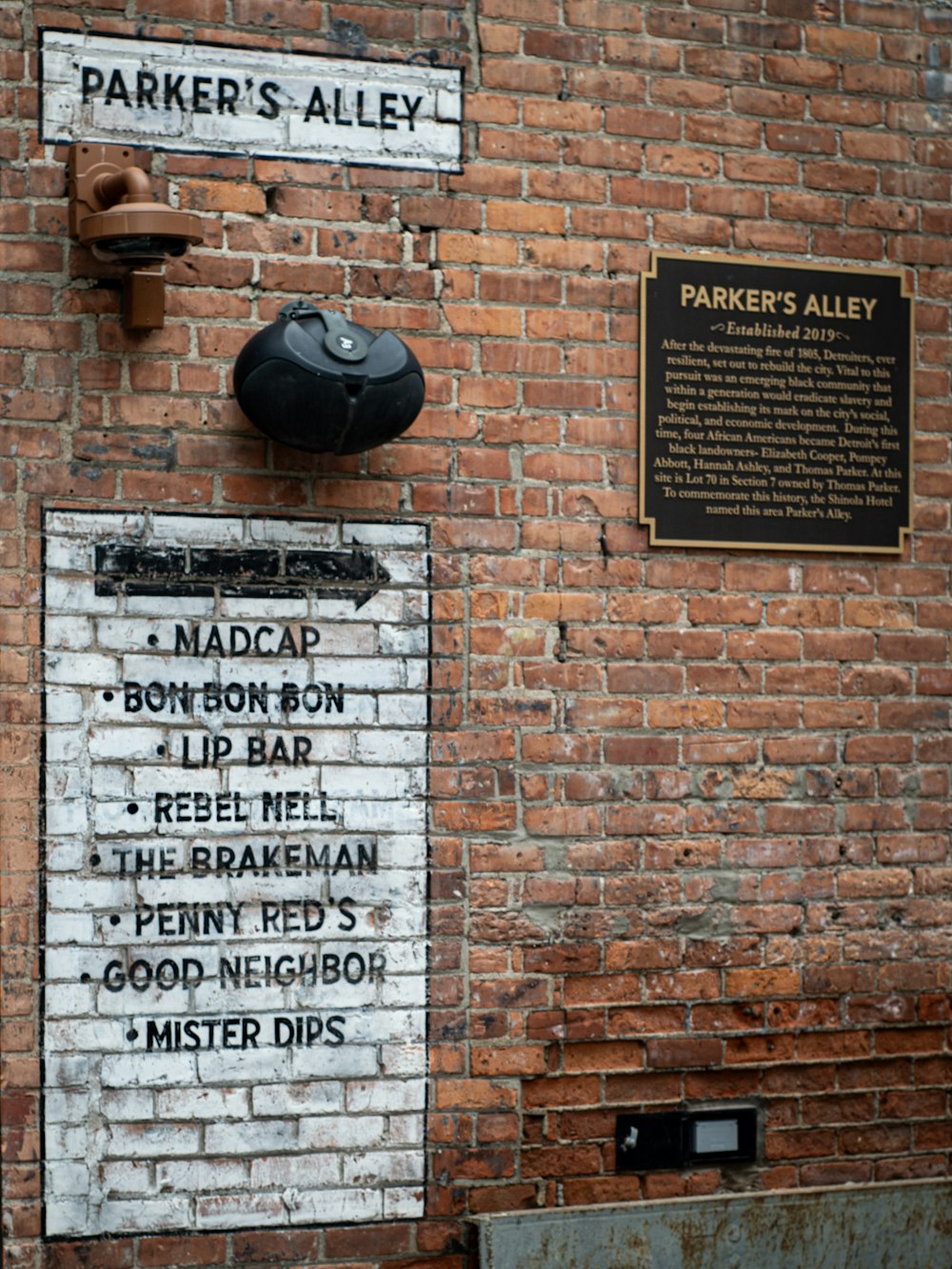 a brick wall with a sign on it