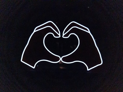 A sleek, modern illustration of two hands holding a glowing heart, symbolizing connection and trust.
