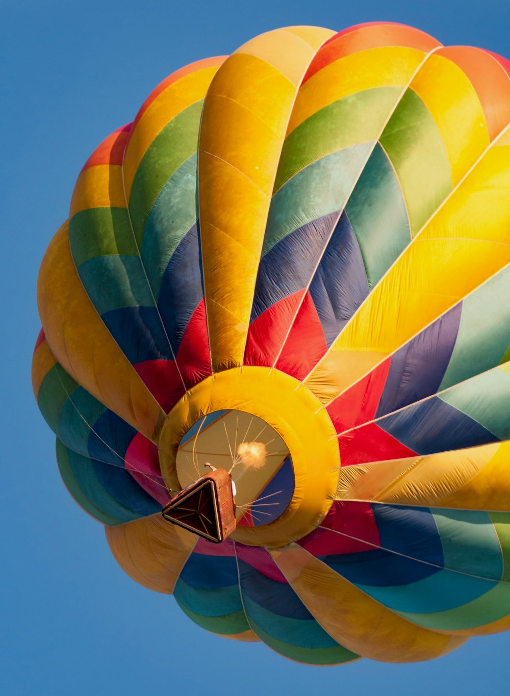 a colorful hot air balloon flying in a blue sky