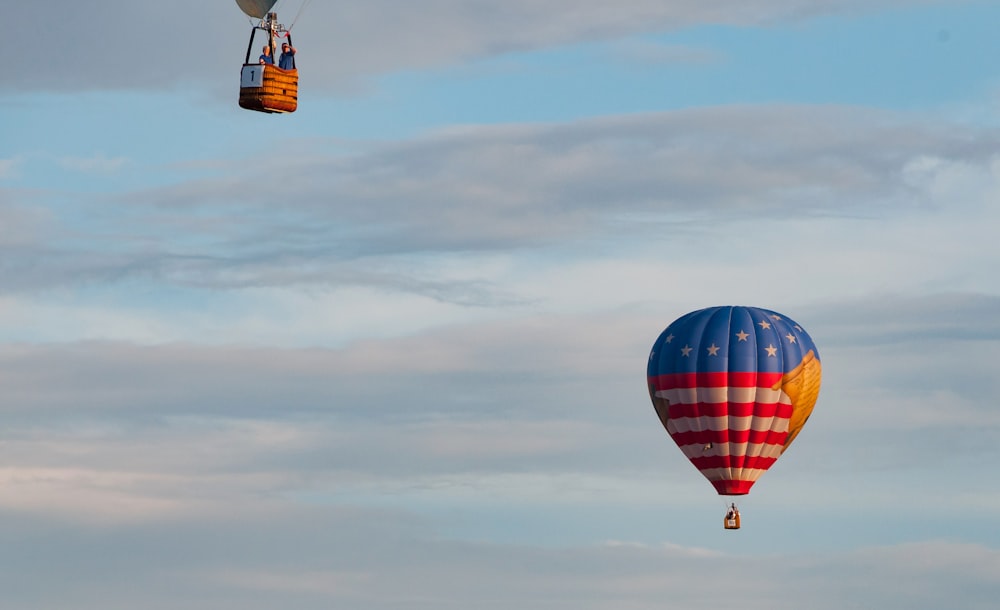 two hot air balloons flying in the sky